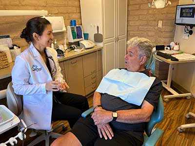 Dr. Ju educating a patient on laser dentistry