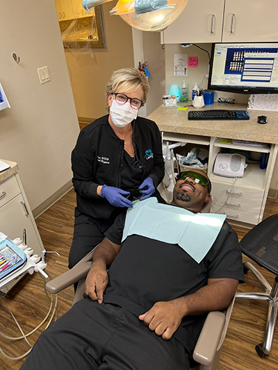 doctor at Creative Smiles Dentistry performing a root canal on a patient